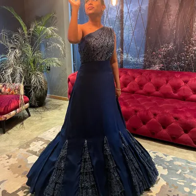 This versatile and chic blue gown effortlessly takes you from a wedding reception to a glamorous cocktail affair. The structured mermaid-style flare adds a touch of dramatic elegance.