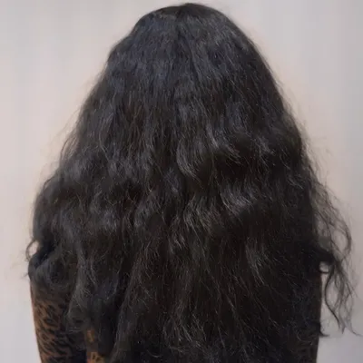 Before: This client was dealing with frizz and unruly texture. She wanted a smoother, more manageable style without harsh chemicals.