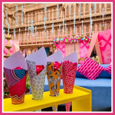 The little details make the theme. For our Rajasthani mela, we used custom-printed paper cones filled with fresh rose petals, adding a pop of color and tradition for guests to enjoy.