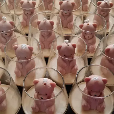 A large batch of my teddy bear jar candles, prepared as return favors for a birthday party. Each bear is carefully placed inside a modern glass jar.