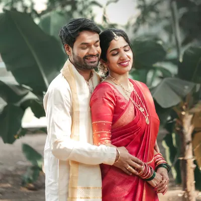 A serene portrait of a South Indian couple in a lush, green setting. We love using natural environments to create calm and romantic wedding photos.