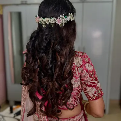 Soft, romantic curls crowned with a delicate fresh flower tiara. This hairstyle is perfect for a daytime engagement or garden wedding.