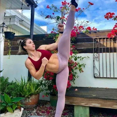 A demonstration of peak physical conditioning and technique. This student's high kick shows the power and definition that comes from our rigorous training programs.