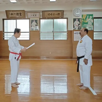 A formal moment at the Shorin-ryu Shorinkan Honbu Dojo in Okinawa as Hanshi Minoru Nakazato reads the declaration for my Kyoshi Nanadan (7th Dan) rank. This connection to the source is vital.