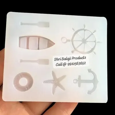 Dive into creativity with my ocean-themed silicone mold. It features various shapes like a ship's wheel, anchor, boat, and starfish, perfect for making nautical-inspired soaps or candle embeds.