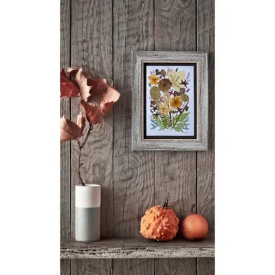 This piece is made from real pressed flowers and leaves that I've collected from my travels. It's a little piece of nature, preserved forever in a frame.