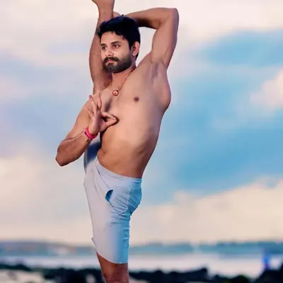 An advanced student demonstrates a standing split variation, showcasing the level of flexibility and strength that can be achieved through dedicated practice.