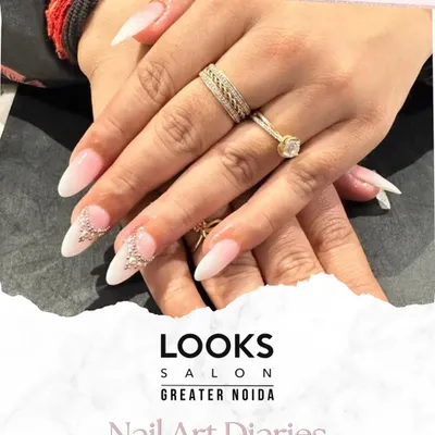 A perfect example of bridal nail artistry. These elegant almond-shaped extensions are finished with a classic French manicure base and accented with delicate 3D crystal embellishments for that extra sparkle on the big day.
