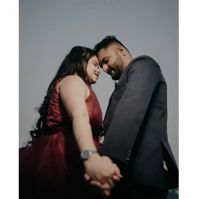 A classic, intimate pre-wedding pose. Holding hands and touching foreheads creates a powerful feeling of connection.