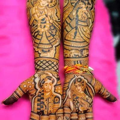 A complete bridal mehndi set featuring personalized portraits of the couple on the palms and figures of Radha and Krishna on the arms. This is the ultimate personalized bridal art.