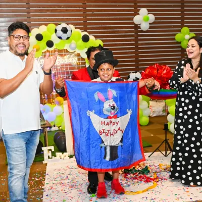 The pure joy and excitement on the guests' faces during a magic show. This magician, arranged for an Arsenal-themed birthday, ended his performance with a surprise "Happy Birthday" banner.