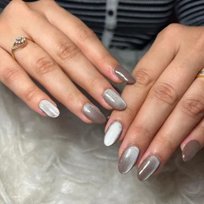 Cat-eye nails are so trendy. This set features a mix of a brown and a white cat-eye effect for a unique look.