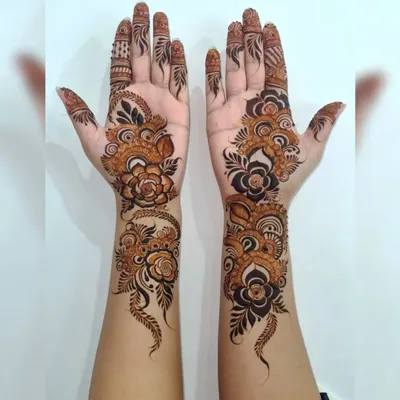 For a modern and bold statement, I love creating Arabic-style henna. This design features prominent floral vines that flow elegantly along the hands, leaving open space to make the pattern pop.