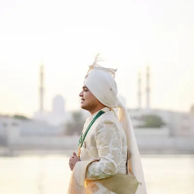 A groom stands at the threshold of a new life. We captured Rishab against the majestic Abu Dhabi skyline at sunrise, a moment of quiet reflection and strength before the day's celebrations began.