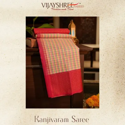 A Kanjivaram that plays with color. This saree features vibrant multicolor checks, grounded by a traditional red korvai gap border and pallu.