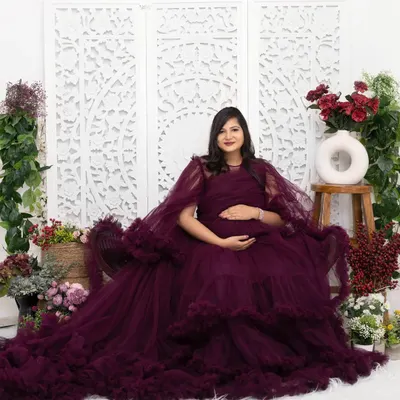 Feel like royalty in one of my lavish gowns. This portrait was taken in my studio, using an elaborate floral set and a carved backdrop to create a rich, luxurious atmosphere for this special memory.
