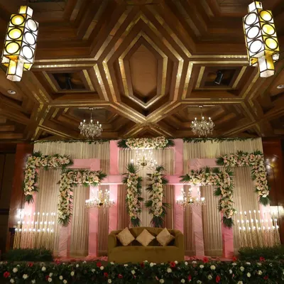 The stunning stage and ceiling decor of a wedding venue. We capture wide shots to show the full scale and ambiance of your chosen location.