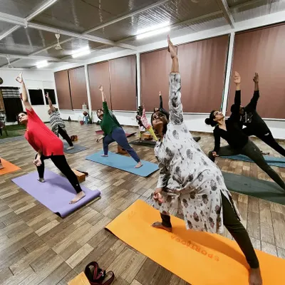 A glimpse into our group class practicing Trikonasana. I ensure everyone, regardless of their level, learns the correct posture to get the full benefits of each asana in a safe and supportive environment.