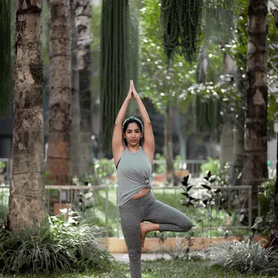 Finding stability in Vriksasana, or Tree Pose, surrounded by greenery. Practicing this grounding pose in nature is a powerful reminder of our connection to the earth and our own inner strength.