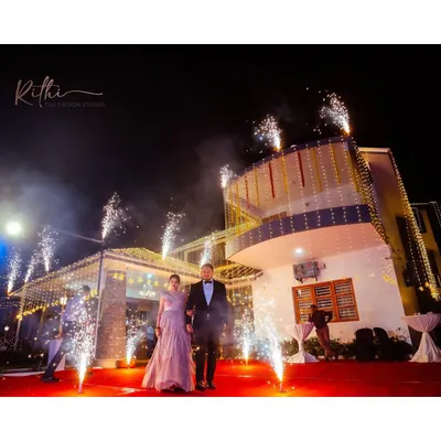 Making a grand entrance at their cocktail party. The groom wears a sleek black velvet tuxedo I designed, creating a dramatic and sophisticated look as they walk down the red carpet.