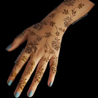A delicate and minimalist floral vine design. This pattern gracefully trails from the forearm down to the fingers, perfect for someone who wants an elegant and subtle look.