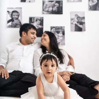 The birthday girl takes center stage in front of a backdrop filled with her family's cherished memories.