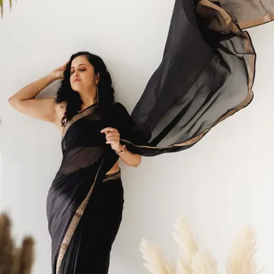 A dramatic pose with a flowing black saree. For this look, I kept the makeup very minimal and focused on a flawless, glowing skin finish to complement the simplicity and elegance of the saree.
