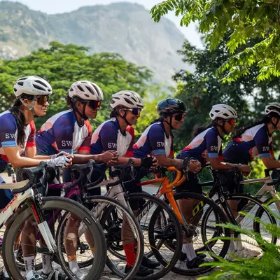 Taking a moment to catch our breath with Nandi Hills in the background. Our team, united in our 'Mountains Are Calling' kit, showcases the sleek fit and design of our performance jerseys during a challenging climb.