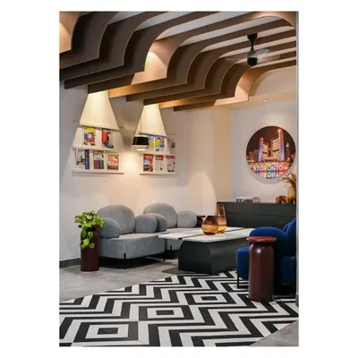 For the Centennial College office in Bangalore, we broke the barriers of a stereotypical work environment. The reception lounge uses bold geometric floor tiles, comfortable curved sofas, and unique ceiling fins to create a welcoming and dynamic first impression.