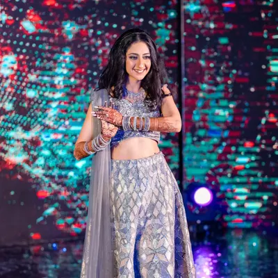Ready to own the dance floor. This bride's sangeet makeup was all about shimmer and shine, with sparkling silver eyeshadow and a flawless base that stayed put all night long.