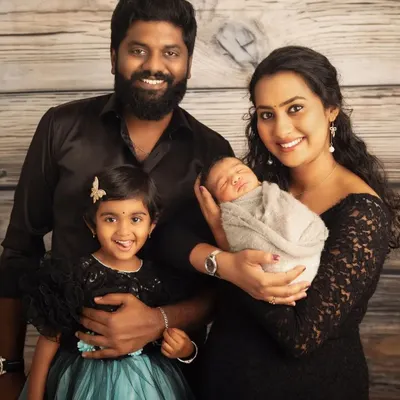 A classic family portrait with everyone looking towards the camera. This image celebrates the completion of their family of four, a beautiful, formal keepsake for their home.
