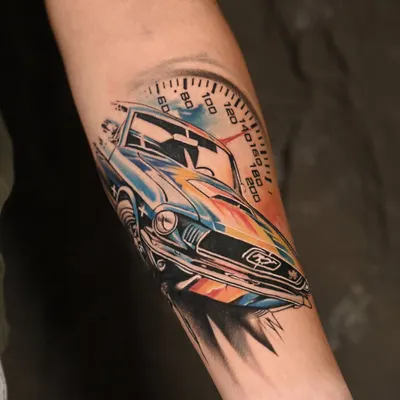 A fusion of mechanical precision and artistic freedom. This color realism tattoo of a classic car uses a vibrant watercolor splash to create a sense of speed and energy, while the car itself is rendered in crisp detail.