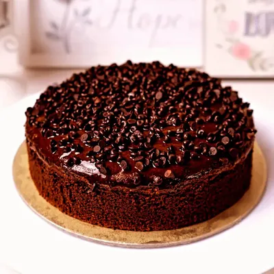 A rich and decadent chocolate truffle cake, generously covered with chocolate chips for the ultimate indulgence.