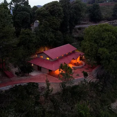 An evening view of the Sargakhet Handicraft Centre, nestled in the hills of Mukteshwar. The warm lighting highlights the restored structure, creating a welcoming beacon for visitors.