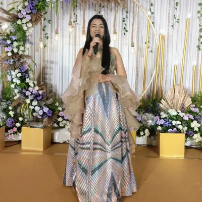 All set to take the stage and kick off a beautiful engagement ceremony. With a stunning backdrop and a mic in hand, I'm ready to weave together moments of tradition, love, and celebration.
