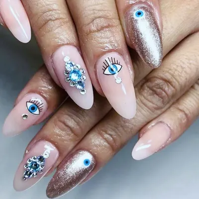A perfect example of detailed custom work. These almond gel extensions feature hand-painted evil-eye art, a full coverage chrome glitter nail, and precisely applied blue crystal clusters for a truly unique and protective design.