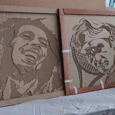 Our signature upcycled art. We find it so satisfying to give discarded materials a new life, like these portraits of Bob Marley and Roger Federer carved from old cardboard boxes.