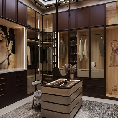 This dream dressing room features rich, wine-toned cabinetry paired with warm wood finishes. A custom central island holds accessories, while a swivel mirror adds sculptural charm and function.