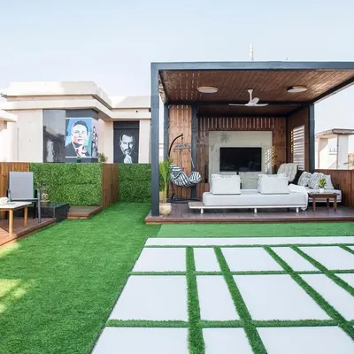 This is the main view of the penthouse terrace I designed. It features a wooden pergola for shaded seating, an open lawn area for gatherings, and a dedicated bar space, all designed to maximize the stunning city views.
