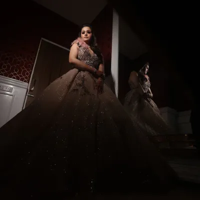 A dramatic, low-key portrait of a bride in her magnificent gown. The use of shadow and light creates a powerful and artistic image.