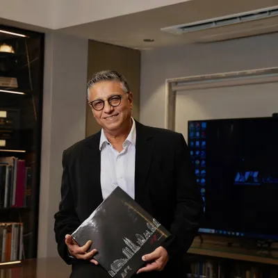 A portrait of me in my office. With over 37 years of architectural excellence, my philosophy is to liberate spaces, blending artistry, function, and sustainability to create designs that inspire and stand the test of time.