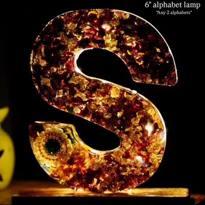 A 6-inch alphabet lamp, in the letter 'S', made with preserved flowers and gold flakes. These lamps come in a set of any two alphabets.