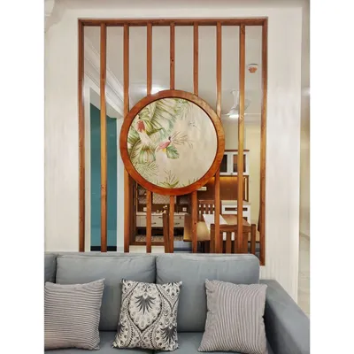 This living room in #TheDivinityHome is designed for effortless elegance. The custom wooden partition with inlaid art serves as a stunning focal point, separating the living and dining areas without closing off the space.