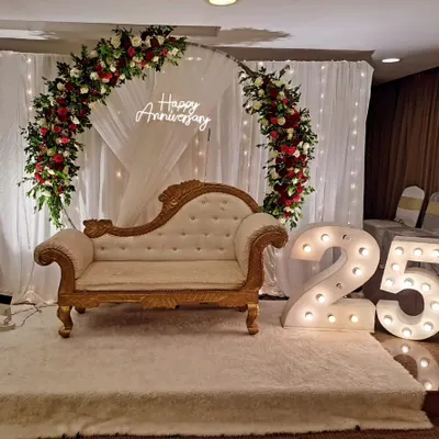A classic and elegant setup for a 25th anniversary celebration. We used a floral arch, a "Happy Anniversary" neon sign, and large illuminated numbers to create a beautiful focal point for the happy couple.