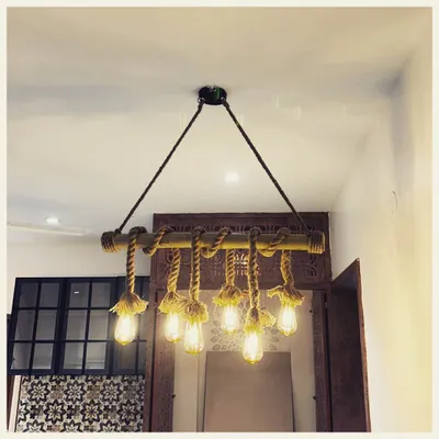This handcrafted light fixture tells a story of rustic charm. We used a bamboo rod and natural rope to suspend multiple Edison bulbs, creating a warm and characterful centerpiece that elevates the entire space.