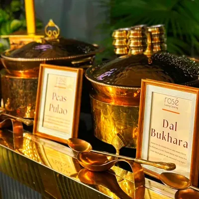 A close-up of our signature Dal Bukhara and Peas Pulao, served in magnificent hammered-brass pots. Our unwavering dedication to culinary mastery ensures a flawlessly executed event that will captivate your guests.