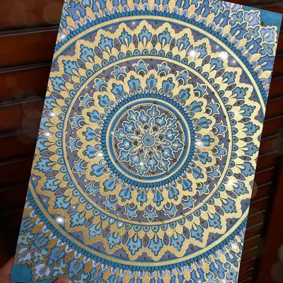 A full view of the detailed blue and gold mandala, created on A4 acrylic paper. The metallic gold paint catches the light beautifully, adding a touch of luxury to the intricate patterns.
