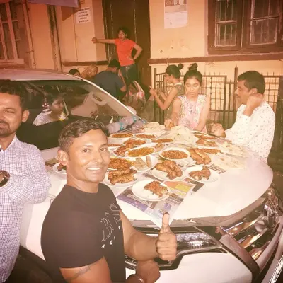 This is our kind of five-star dining. No reservations needed, just pull up, and your car bonnet becomes the best table in Mumbai. It's the real, chaotic, and beautiful street dining experience.