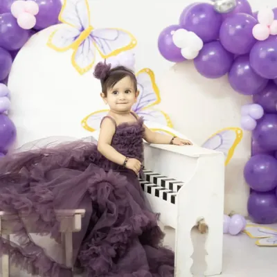 Planning a pre-birthday shoot for your little princess? This grand mauve ruffle gown will make her feel like she's in a fairytale. It's available for both rent and purchase.
