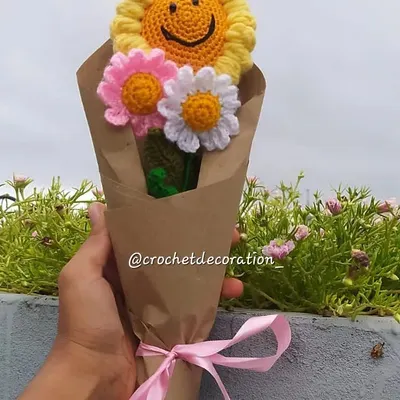 A beautiful custom bouquet wrapped and ready to be shipped. This one features a smiley sunflower and daisies, making for a cheerful and lasting gift.